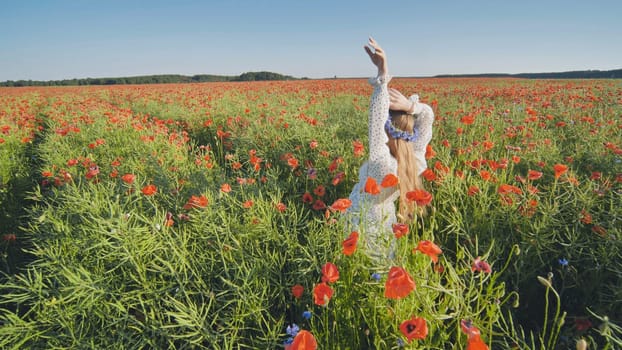 Slavic woman with long blond hair wearing flower crown and white dress, raising her arms in a beautiful poppy field
