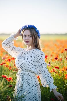 Slavic female modeling floral headpiece among blooming red poppies, sunlight highlighting delicate features