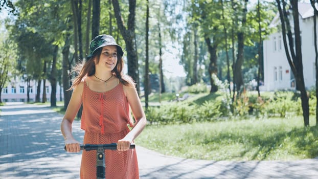 Teenager riding an electric scooter through a vibrant summer park, soaking up the sun and enjoying a carefree day outdoors
