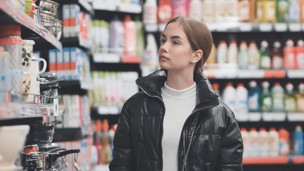 Customer looking up at shelves, making purchasing decisions in grocery store, navigating retail environment