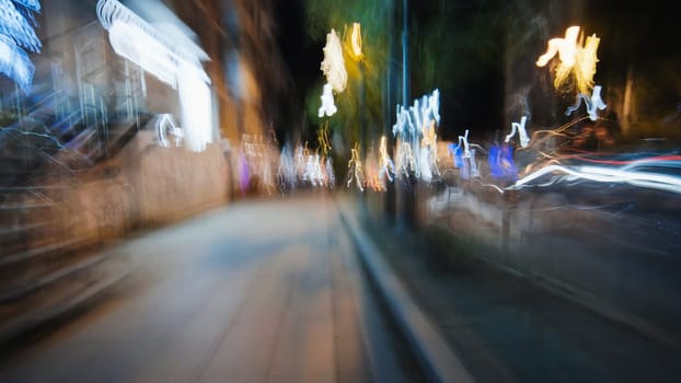 City street engulfed by luminous light trails, generating abstract nocturnal motion blur against dark urban backdrop