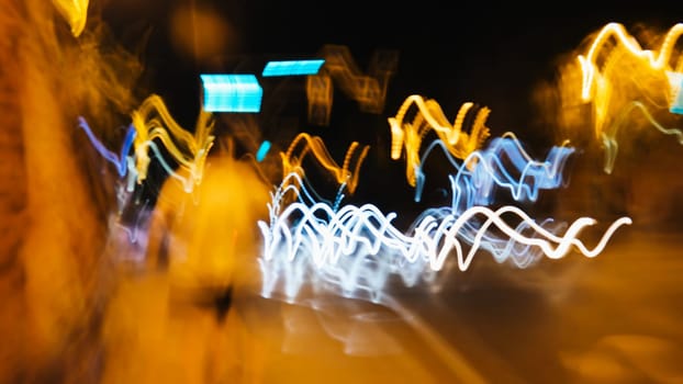 Light trails weaving dynamic energy, blurring colorful streaks against deep black background, representing rapid motion and visual excitement