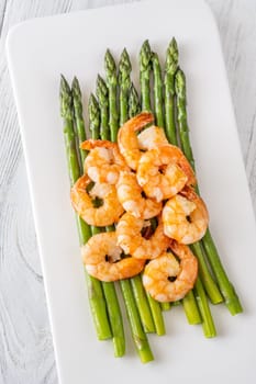 Golden shrimp add crunch and color to soft green spears of asparagus