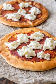Golden crusts cradle warm stracciatella and sauce, accented with sprigs of thyme