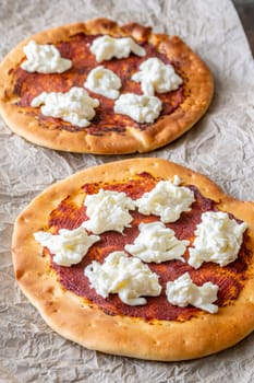 Golden crusts cradle warm stracciatella and sauce, accented with sprigs of thyme