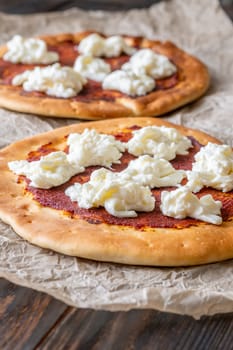 Golden crusts cradle warm stracciatella and sauce, accented with sprigs of thyme