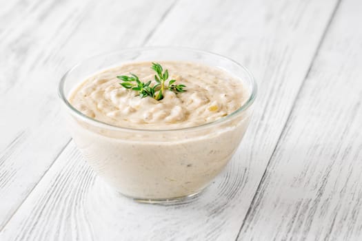 Herbed sauce glows softly as thyme floats atop rich, tangy blue cheese