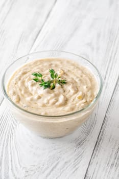 Herbed sauce glows softly as thyme floats atop rich, tangy blue cheese