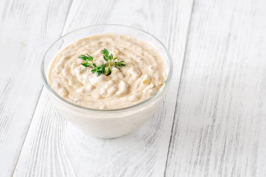 Herbed sauce glows softly as thyme floats atop rich, tangy blue cheese