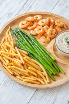Crispy shrimp and fries balance soft asparagus and creamy sauce with thyme