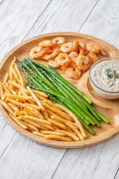 Crispy shrimp and fries balance soft asparagus and creamy sauce with thyme