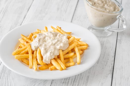 Creamy sauce melts into warm fries, creating a bold flavor experience together