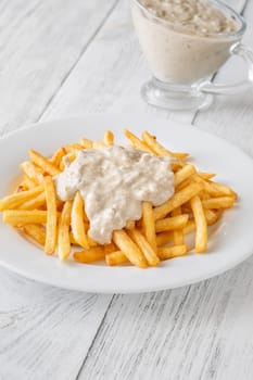 Creamy sauce melts into warm fries, creating a bold flavor experience together