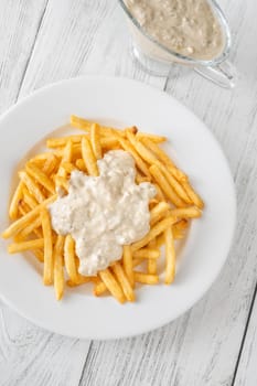 Creamy sauce melts into warm fries, creating a bold flavor experience together