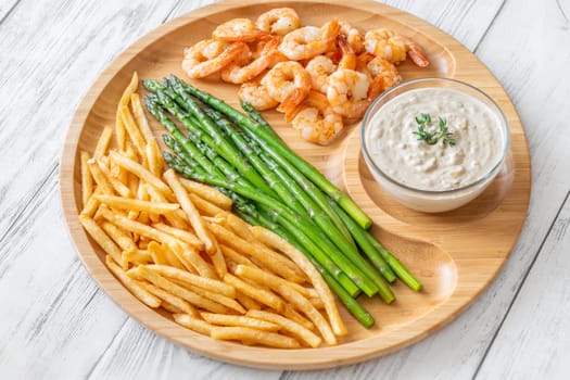 Crispy shrimp and fries balance soft asparagus and creamy sauce with thyme