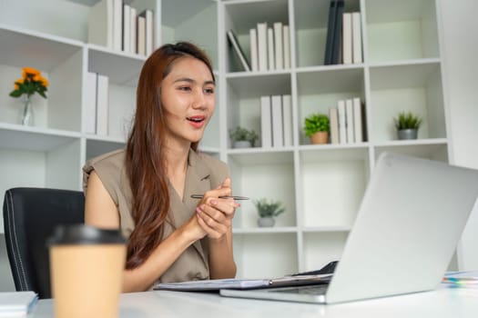 A young professional engages in a video conference, showcasing excitement and involvement while discussing important topics, emphasizing modern remote work practices.