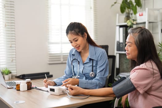 During a routine consultation, a nurse checks the blood pressure of an elderly woman, offering medical guidance and support in a comforting atmosphere.