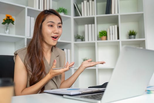 During a virtual meeting, a woman expresses her thoughts enthusiastically, using hand gestures to communicate effectively, enhancing engagement with her audience.