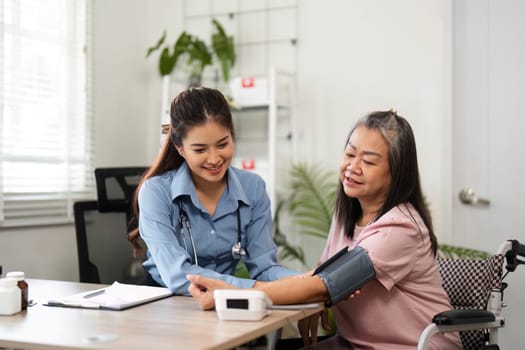 A nurse engages with an elderly patient, checking her blood pressure and discussing medication in a warm healthcare setting, ensuring her well-being.