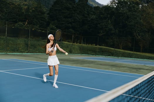 Joyful female tennis player dressed in white sports attire, playing on a bright blue court, showcasing athleticism and the happiness of outdoor sports in a vibrant natural setting