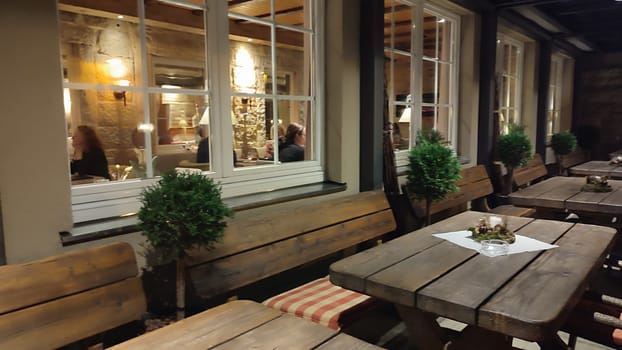 October 17 2024 Bad Schandau Germany Europe Outdoor wooden seating table object book travel shotlisttravel cafe windows editorial photo bar wooden design night. High quality photo