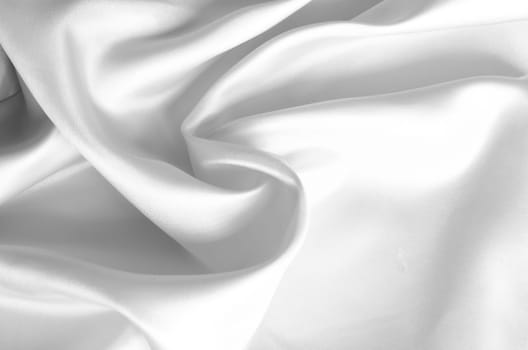 Top view of white shining silk showing detailed texture and radiant light reflections. Suitable for design and wallpaper background.