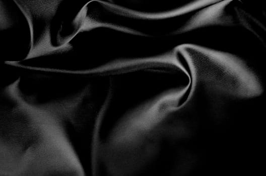Top view of dark fabric showing smooth texture. Suitable for design and wallpaper background.