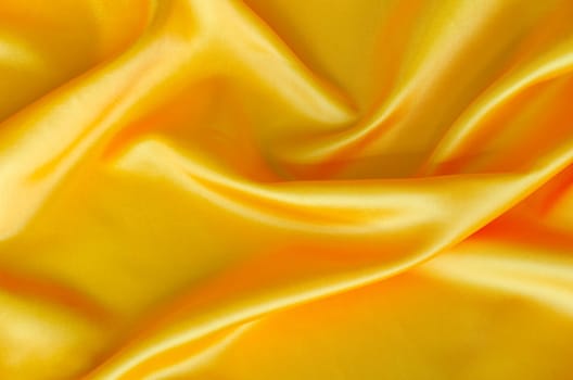 Polished yellow silk cloth with silky sheen and beautiful natural draping. Suitable for design and wallpaper background.