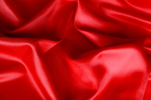 Bright and lustrous dark red fabric showing smooth texture. Suitable for design and wallpaper background.