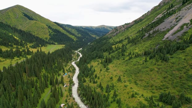 Grigoriev gorge's breathtaking landscape unfolds. Revealing a meandering river flowing through a vibrant green valley. Surrounded by dense forests and rolling hills. A testament to nature's artistry