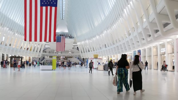 New York City, United States - 10 Sept 2023: World Trade Center Oculus transport hub architecture. Manhattan Downtown Financial District, USA urban life. People. September 11 remembrance american flag