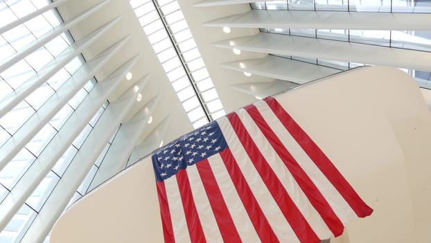 New York City, United States - 10 Sept 2023: World Trade Center Oculus architecture. Manhattan Downtown Financial District, USA. September 11 remembrance, large memorial american flag. 911 Patriot day