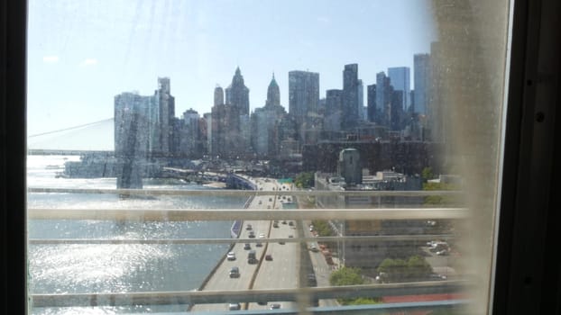 New York City, United States - 14 Sept 2023: Subway train, Manhattan bridge. Shaking camera, dirty window. Metro transport metropolitan traffic. Passenger railway. Downtown skyline. World Trade Center