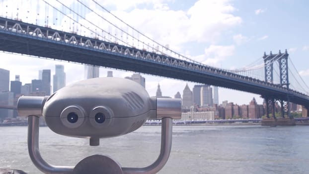 New York City, United States - 30 Aug 2023: Manhattan Bridge lookout, tower viewer binoculars, Brooklyn Dumbo. Waterfront downtown cityscape, skyscraper skyline. East River tourist promenade.
