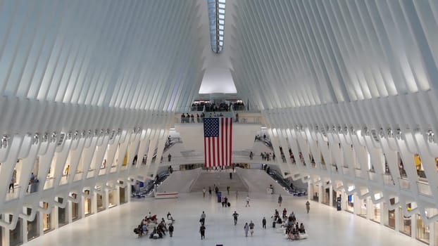 New York City, United States - 10 Sept 2023: World Trade Center Oculus transport hub architecture. Manhattan Downtown Financial District, USA urban life. People. September 11 remembrance american flag