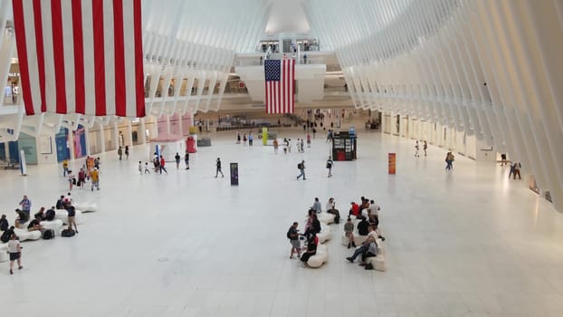 New York City, United States - 10 Sept 2023: World Trade Center Oculus transport hub architecture. Manhattan Downtown Financial District, USA urban life. People. September 11 remembrance american flag
