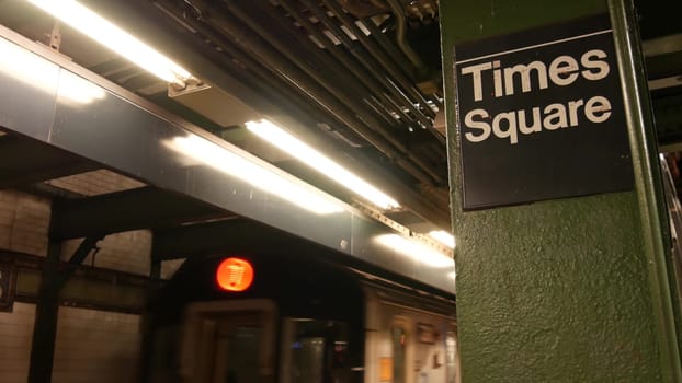 New York City, United States - 1 Sept 2023: Subway station, underground metropolitan train platform sign. Metro railway passenger public transport. Times Square text signboard. People. Manhattan.