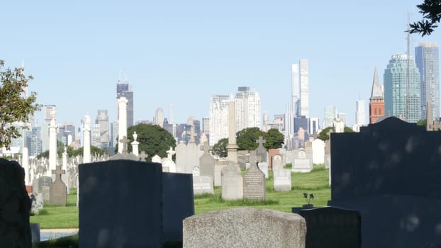 New York City, United States - 14 Sept 2023: Calvary cemetery in Queens, USA. Manhattan Midtown urban skyline cityscape architecture. Tombstones on graves, huge graveyard. Large cemetry grass lawn.