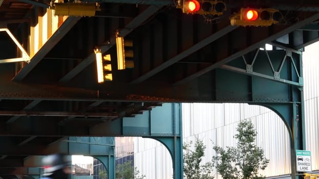 New York City, United States - 2 Sept 2023: Elevated subway, metropolitan bridge, metro track above street. Railway transport over road. Queens old railroad line, Long Island. Yellow traffic light.