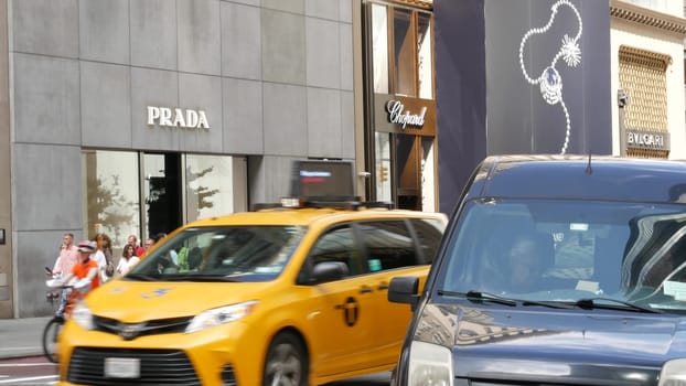 New York City, United States - 13 Sept 2023: Manhattan Midtown street, Fifth 5 avenue. American urban road car traffic. Yellow taxi cab in USA. People pedestrians. Boutique fashion stores for shopping