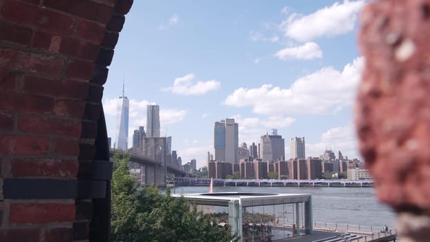 New York City, United States - 30 Aug 2023: Manhattan downtown skyline, waterfront cityscape from Time Out Market. Riverfront Carousel in Dumbo near Brooklyn Bridge. World Trade Center skyscraper.