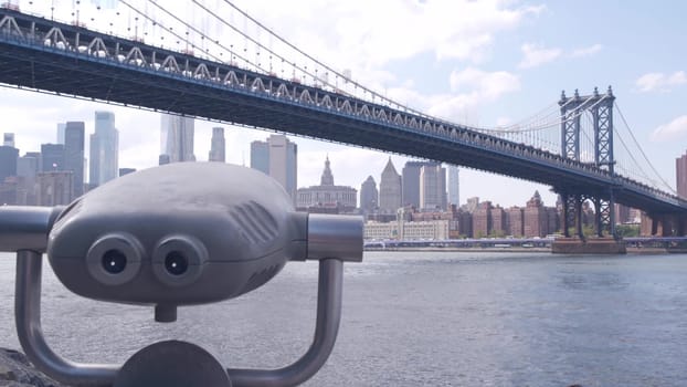 New York City, United States - 30 Aug 2023: Manhattan Bridge lookout, tower viewer binoculars, Brooklyn Dumbo. Waterfront downtown cityscape, skyscraper skyline. East River tourist promenade.