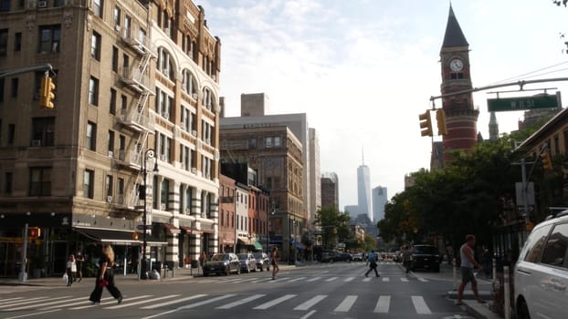 New York City, United States - 10 Sept 2023: Manhattan Greenwich Village street, Sixth 6 Americas avenue crossroad. Road traffic. People, USA World trade center. Jefferson Market Library, clock tower.
