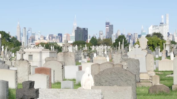 New York City, United States - 14 Sept 2023: Calvary cemetery in Queens, USA. Manhattan Midtown urban skyline cityscape architecture. Tombstones on graves, huge graveyard. Large cemetry grass lawn.
