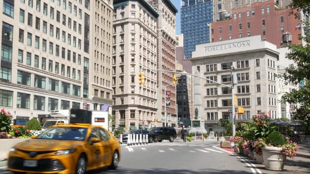 New York City, United States - 6 Sept 2023: Manhattan Midtown Broadway, 23 street, 5 avenue crossroad intersection. Worth Square near Madison Park, Flatiron, USA. Porcelanosa. People. Yellow taxi car