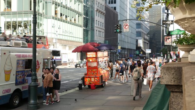New York City, United States - 4 Sept 2023: Manhattan Midtown, Fifth 5 avenue, 42 street intersection corner near Bryant Park and Library, USA. American urban traffic, people, Fast food or street food
