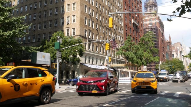 New York City, United States - 8 Sept 2023: Manhattan Greenwich Village street, 5th, Fifth 5 avenue. American urban road car traffic, people. Yellow taxi cab in USA. Empire State building and Forbes.