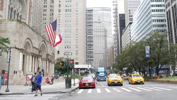 New York City, United States - 11 Sept 2023: Manhattan Midtown street, Park avenue crossroad intersection. Urban road car traffic in USA. People pedestrians, zebra crosswalk. Yellow taxi cab. MetLife.