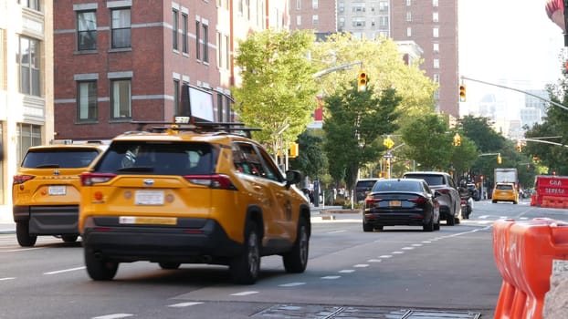 New York City, United States - 2 Sept 2023: Manhattan Midtown street in Chelsea, 9 avenue crossroad intersection. Meatpacking district urban road car traffic, USA. People pedestrians. Yellow taxi cab.