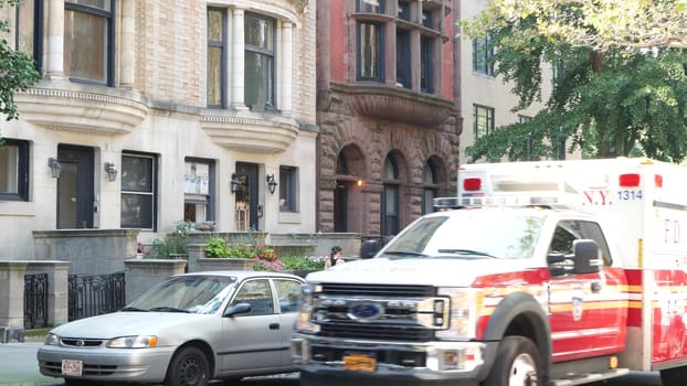 New York City, United States - 7 Sept 2023: NYFD Ambulance medical emergency, american fire department paramedic truck. USA 911 vehicle on street, Brooklyn Heights townhouses. NYC first responders car